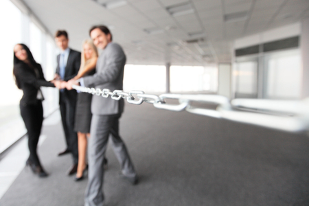 Businessmen pulling chain, teamwork togetherness conceptの写真素材