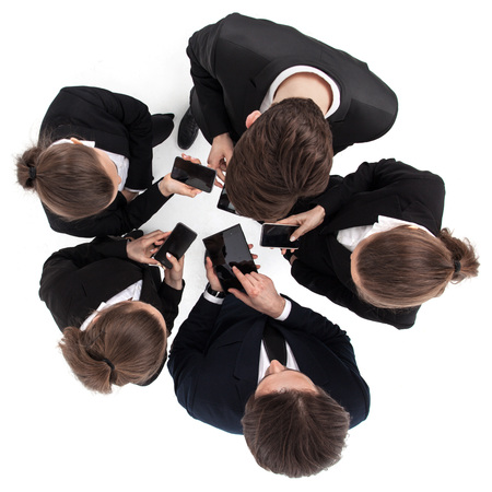 Business people porking with phones and tabletsの写真素材