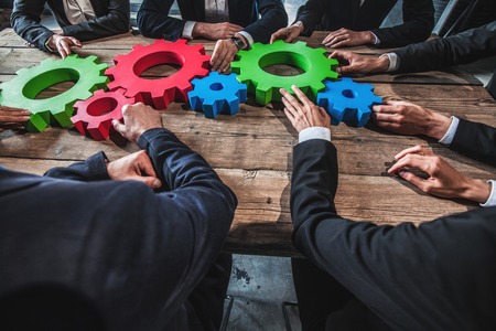 Business people with cogs of business, modern business meeting conceptの写真素材