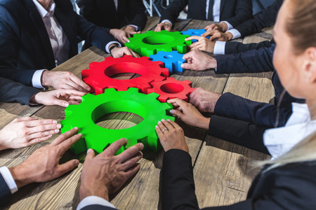 Business people with cogs of business, modern business meeting concept