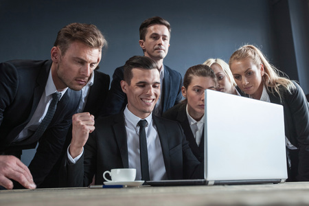 Group of business people using laptop together in office, teamwork conceptの写真素材