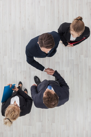 Business people shaking hands, cooperation concept, top viewの写真素材