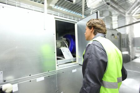 Worker in electrical switchgear room of CNC plantの写真素材