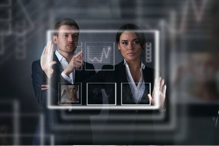 Business people working with virtual display with graphs ans dataの写真素材