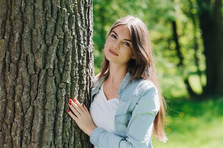 Young woman hugging a big tree, love nature conceptの写真素材
