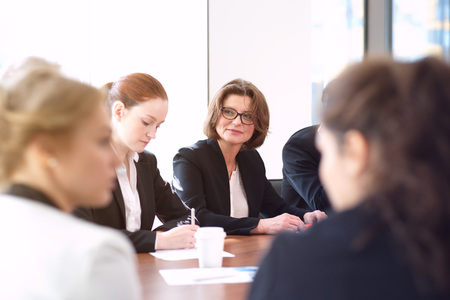Image of business partners discussing documents and ideas at meetingの写真素材