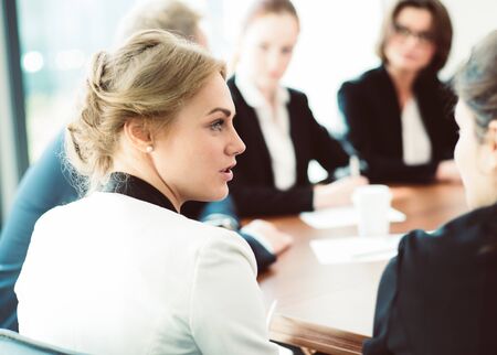 Image of business partners discussing documents and ideas at meetingの写真素材