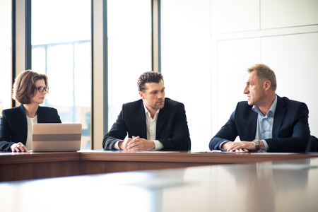 Image of business partners discussing documents and ideas at meetingの写真素材