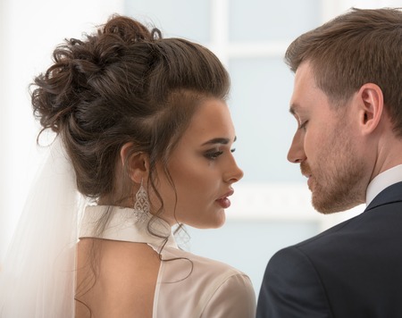 Groom and bride looking each to other at the wedding dayの写真素材