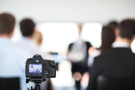 Making video of business people at meeting with photo cameraの写真素材