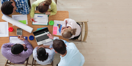 Business team meeting, people in casual clothes working with financial statistics at office desk