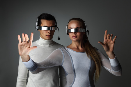 Couple working with futuristic display using futuristic VR goggles, innovation, future conceptの写真素材