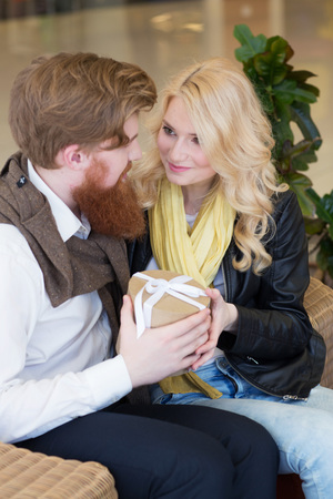 Happy beautiful young girl getting a gift from boyfriendの写真素材