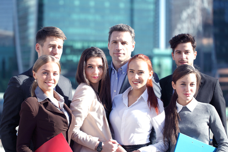 Portrait of business team outside office on skyscrapers backgroundの写真素材