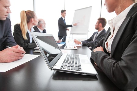 Mixed group of people in business meeting working with documents and computers man with presentation...