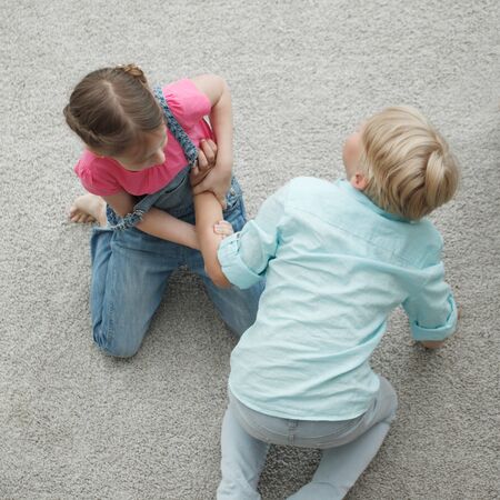 Struggle between two children conflict fighting family concept