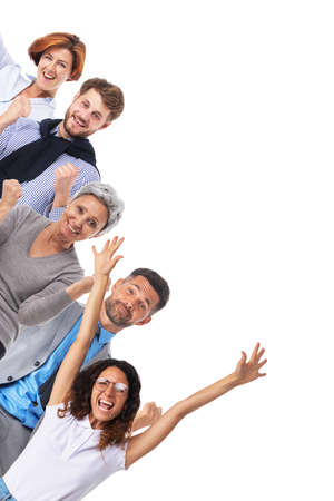 Successful excited business people group team, young businesspeople standing together smile hold fist ok yes gesture with raised hands arms, studio isolated over white backgroundの写真素材