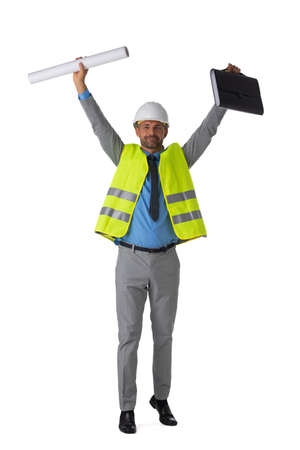Male engeneer architect foreman in white hardhat and safety vest winner with raised arms isolated on white background full length studio portraitの写真素材