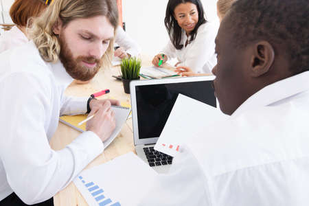 Diverse executive business people team discussing work results at meeting, multiracial businessmen...