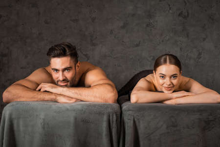 Beautiful couple relaxing together at spa center at beauty treatment massageの写真素材