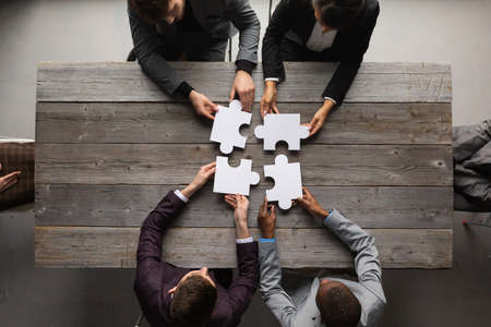 Business teamwork with puzzle finishing project cooperation unity conceptの写真素材