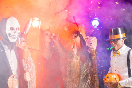 Happy people men and women mixed race dancing together on Halloween partyの写真素材
