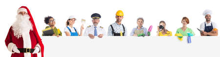 Group of diverse profession workers and Santa Claus holding together empty banner. Isolated on white background, Copy space for textの写真素材