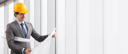 Architect in hardhat and business suit with construction plans