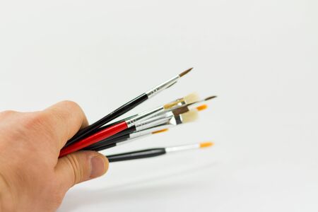 Paint brushes various sizes on handの写真素材