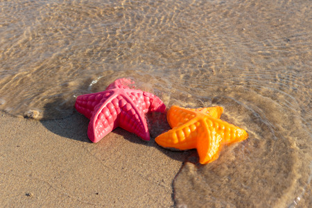 Summer Holiday, Beach Waves Starfish and colored toysの写真素材