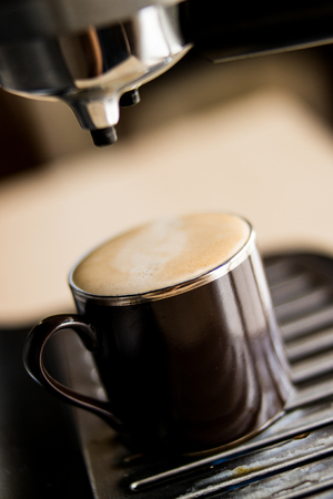 espresso machine making coffee and pouring in a brown  cupの写真素材