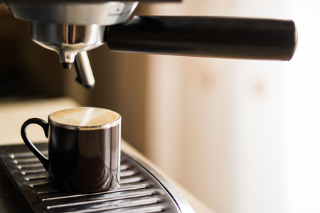 espresso machine making coffee and pouring in a brown  cupの写真素材