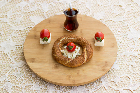 Turkish Bagel Simit with cherry tomatoes, cheese and teaの写真素材