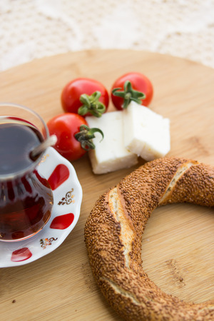 Turkih Bagel Simit with tea, cheese and cherry tomatoes.の写真素材