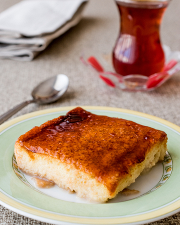 Balkan Dessert Cake Trilece with caramel sauce and tea. dessert concept.