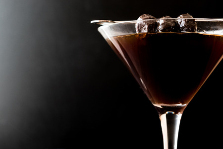 Black Manhattan Cocktail with olives on dark wooden surface. Dark Concept.の写真素材