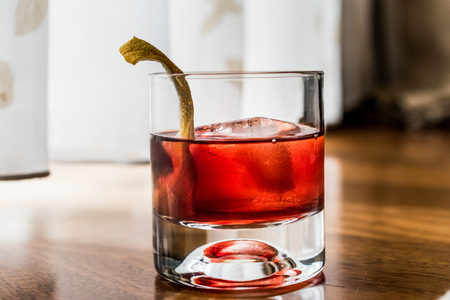 Negroni Cocktail with lemon peel and ice. Beverage Concept.