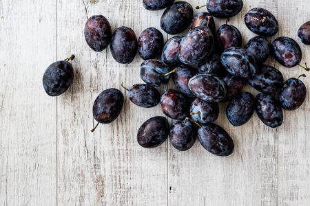 Damson Plum on white wooden surface. organic food concept.の写真素材