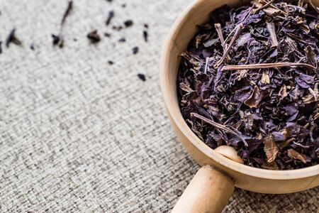 Dried Basil Leaves Herbs in wooden ladle / Reyhan otu. Organic Concept.の写真素材