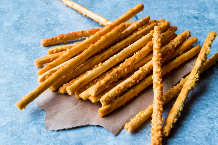 Salty Pretzel Crunchy Sticks on Blue Surface. fast Food