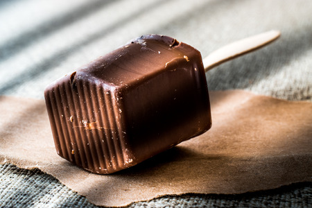 Milky Chocolate with wooden stick (lusty or dim light) . dessert concept.の写真素材
