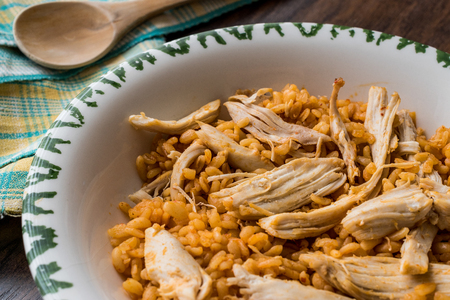 Chicken with bulgur rice on a wooden surface.の写真素材