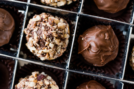 Box of Chocolate Pralines with Hazelnuts. Dessert Concept.の写真素材