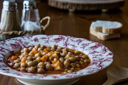 Turkish Nohut Pilaki / Chickpea Stew on a wooden surface.の写真素材