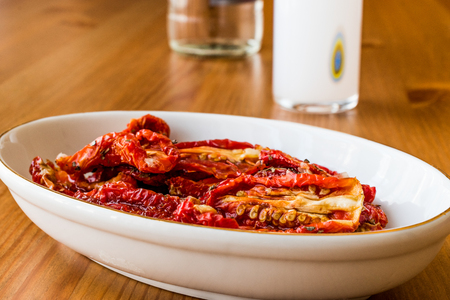 Dried tomatoes with Raki on wooden surface. Turkish Appetizer concept.の写真素材