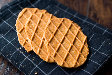 Fresh Crisp Waffles on Black Tablecloth. Dessert Concept.の写真素材