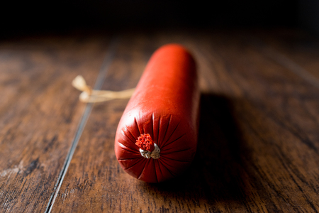 Turkish Baton Sausage Sucuk on dark wooden surface. Traditional Food.の写真素材