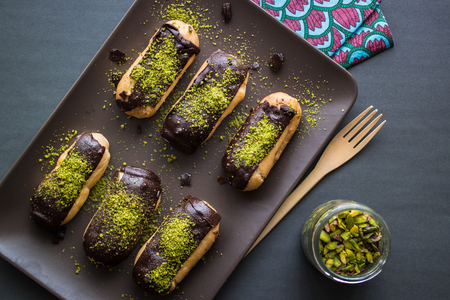 Chocolate Eclairs / Donut with pistachio powderの写真素材