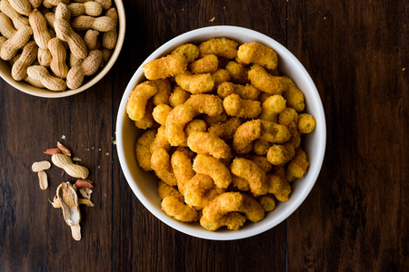 Peanut Chips on dark wooden surface. Fastfood.