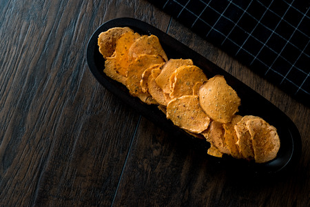 Tarhana cipsi  chips or crackers in a wooden bowl. Appetizer Concept.の写真素材